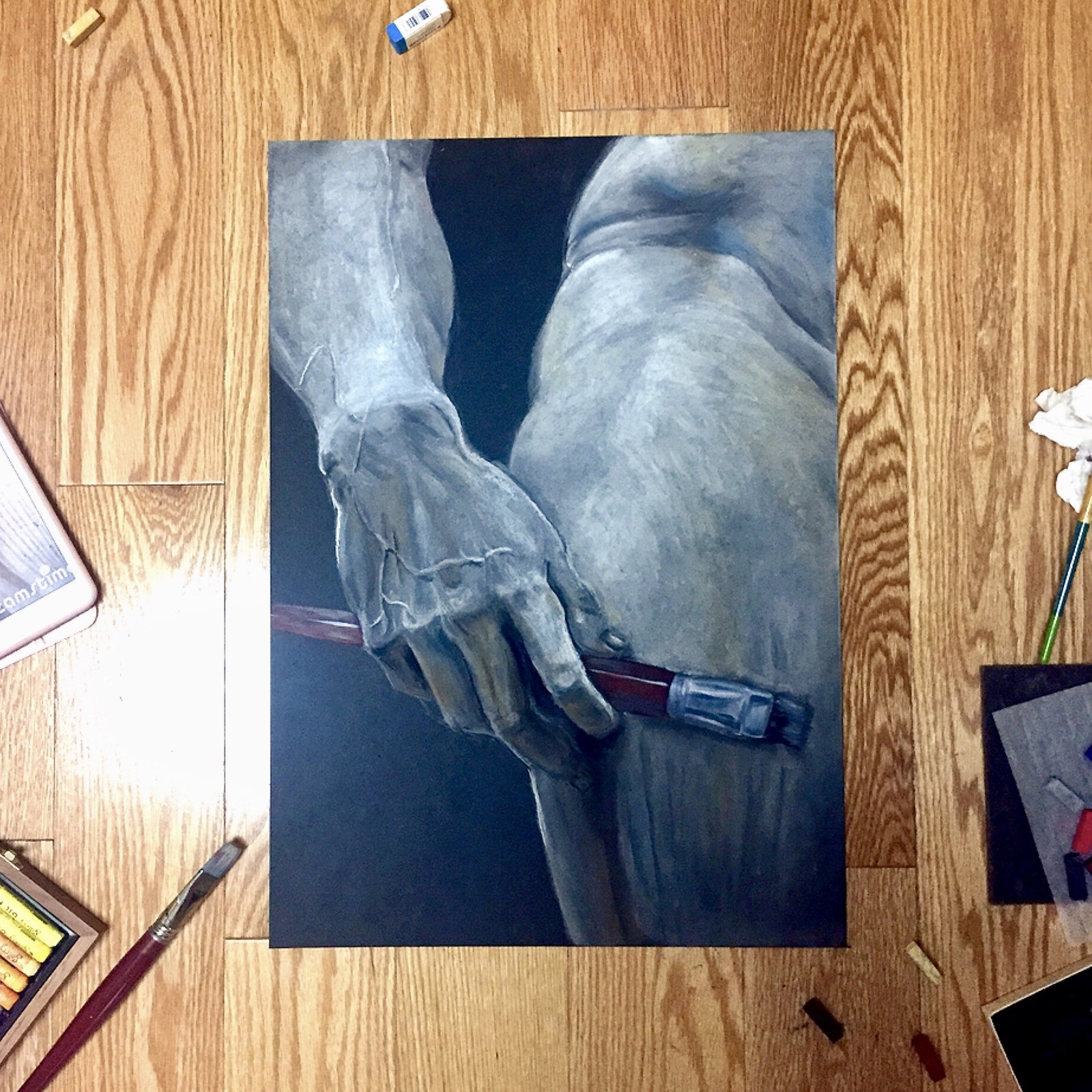 David's hand holding a paint brush.